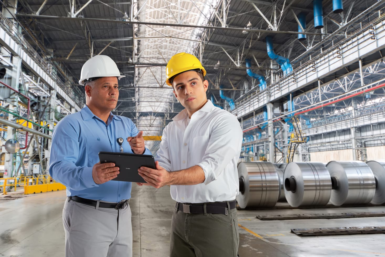 2 Men Wearing Hard Hats in Warehouse